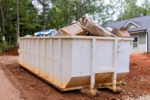 Global 360 Moving team providing junk removal beside rented dumpster in Edmonton