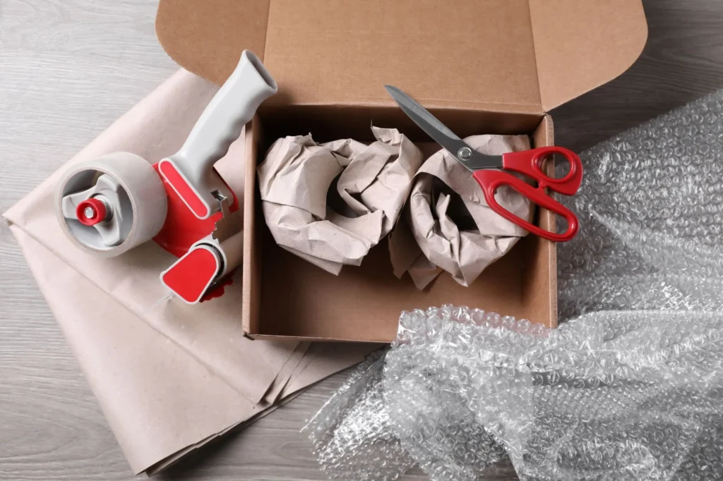 Current image: professional movers using boxes protective wrap and crates during packing