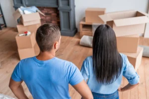 Movers unpacking boxes and organizing household items after a residential move